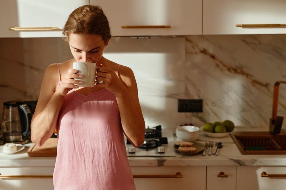 sipping coffee in the kitchen