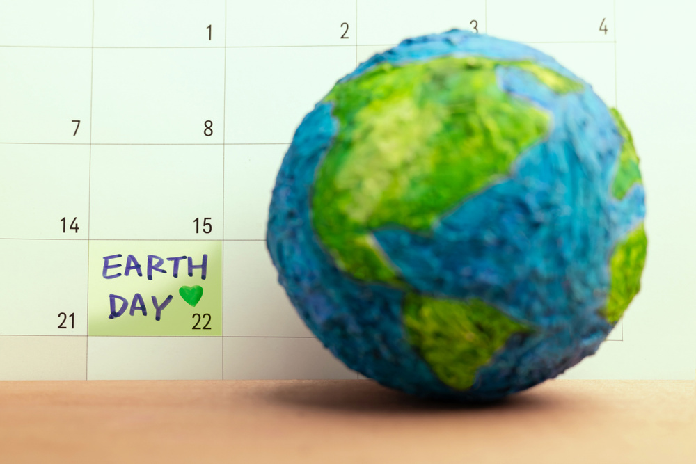 Globe with Earth Day marked on calendar symbolizing global environmental awareness. Concept of sustainability, climate action and worldwide responsibility