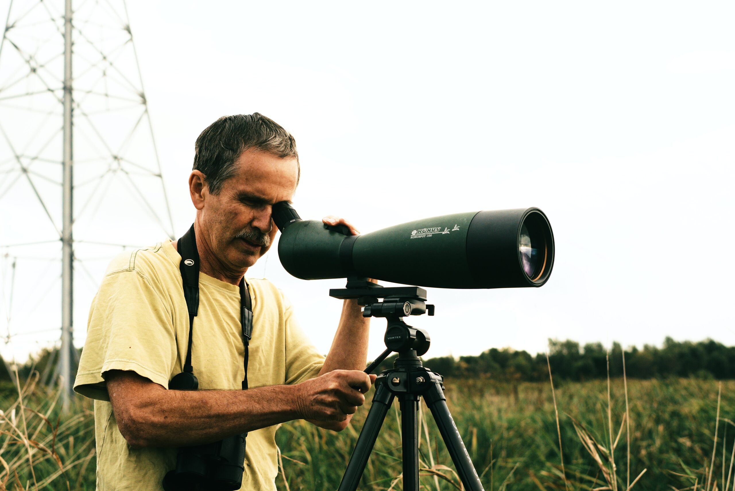 elderly person using a telescope image